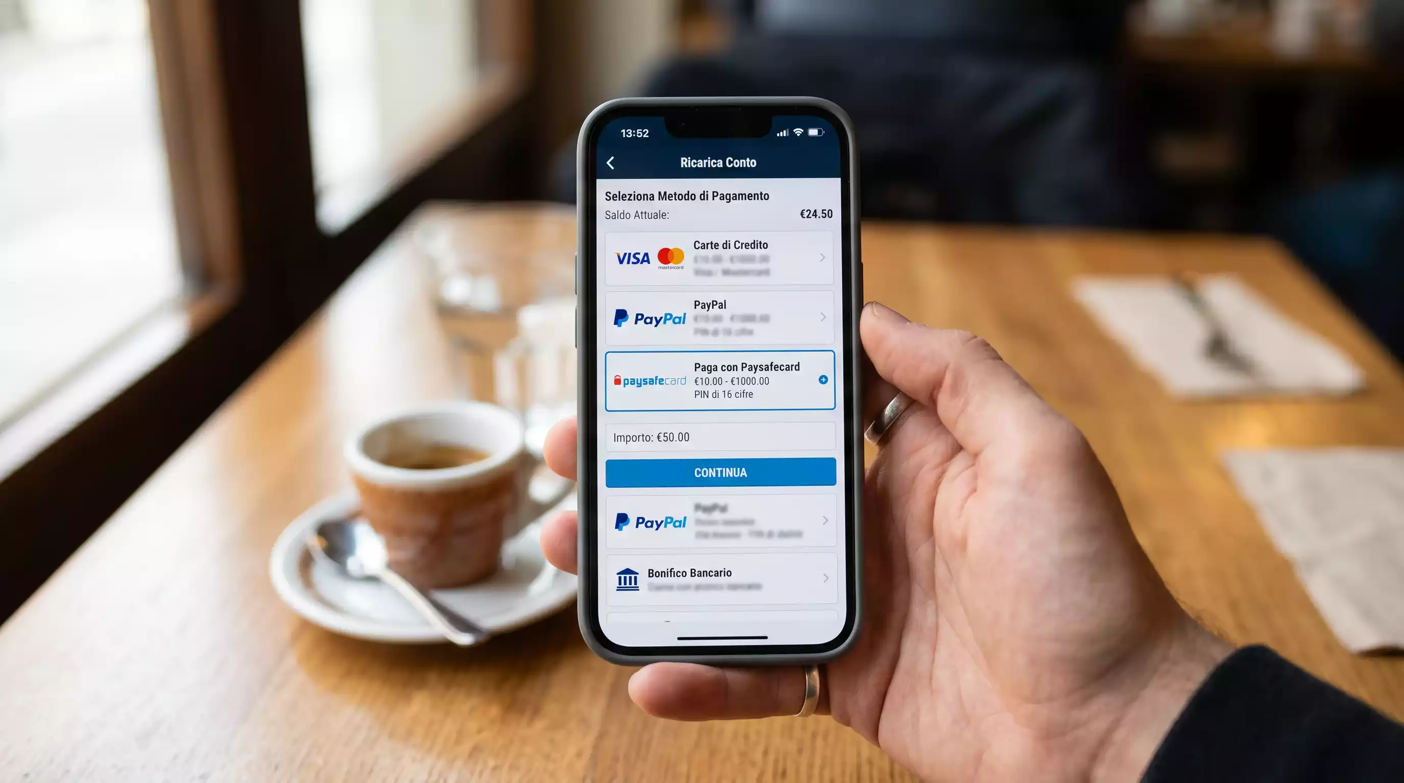 Smartphone con app del bookmaker aperta sulla schermata di deposito Paysafecard tenuto in mano in ambiente urbano